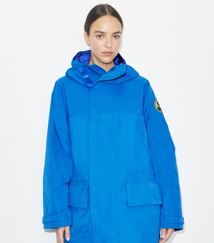 Tory Burch designer jackets The Explorers Club Tech Canvas Hooded Jacket in Bay Blue on model detail