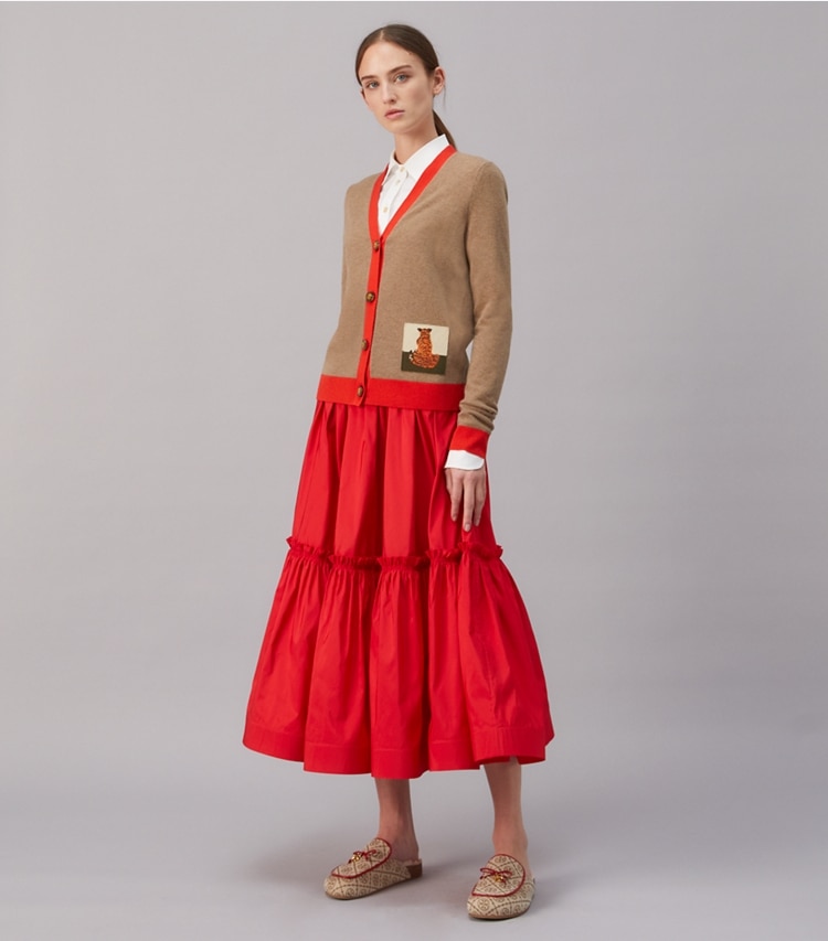 Tory Burch designer sweaters Tiger Patch Cashmere Cardigan in RICH TAUPE / BRILLIANT RED on model front