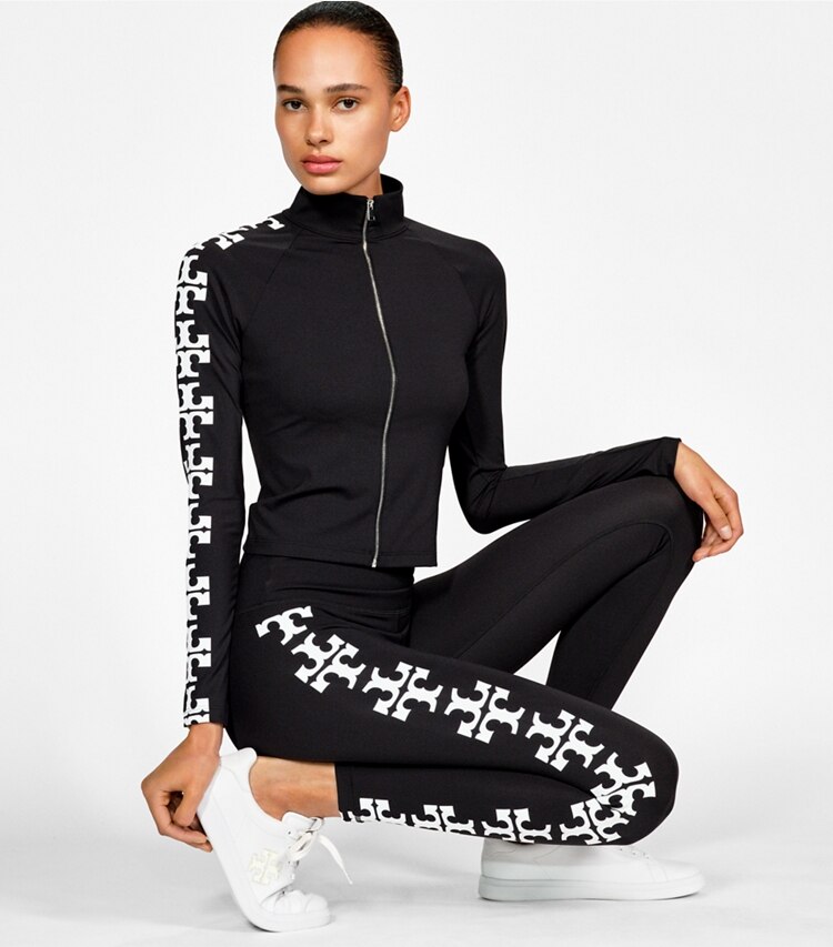 Tory Burch diseñador tops Top con cremallera y logotipo de nailon reflectante en Black campaña