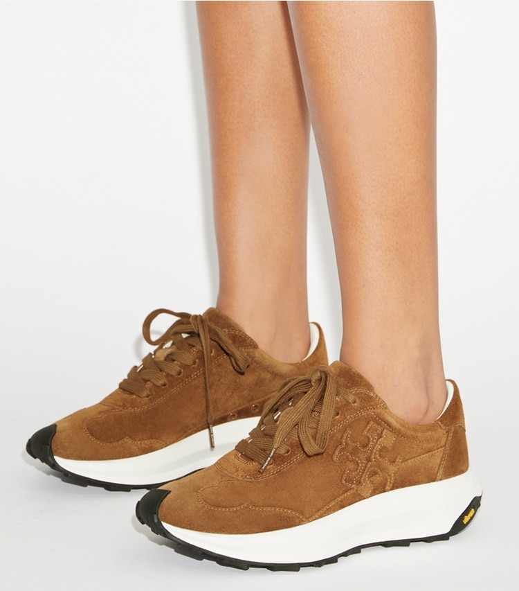 Tory Burch designer sneakers Tory Trainer in COGNAC BROWN accessory on model