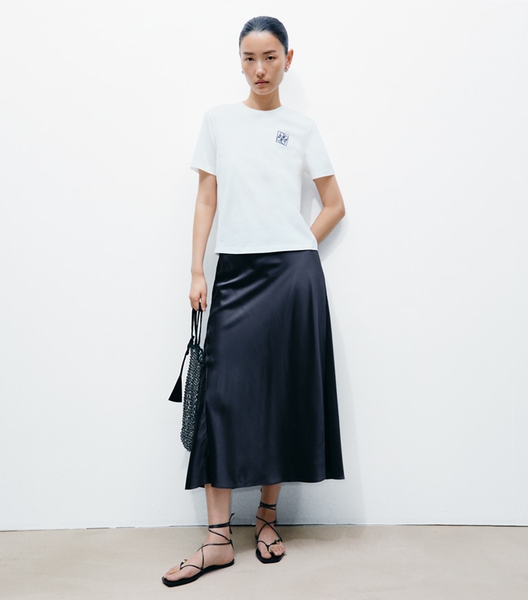 Tory Burch designer tops Twisted Logo T-Shirt in Snow White on model front