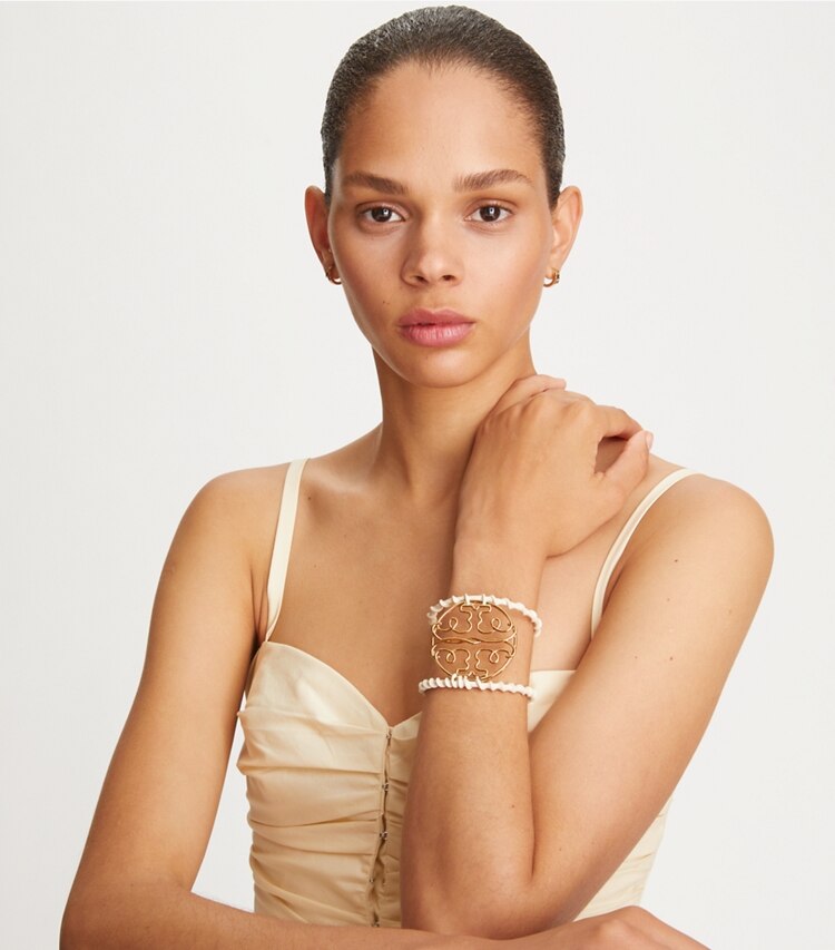 Tory Burch designer bracelets Twisted Miller Cuff in Tory Gold / French Cream accessory on model