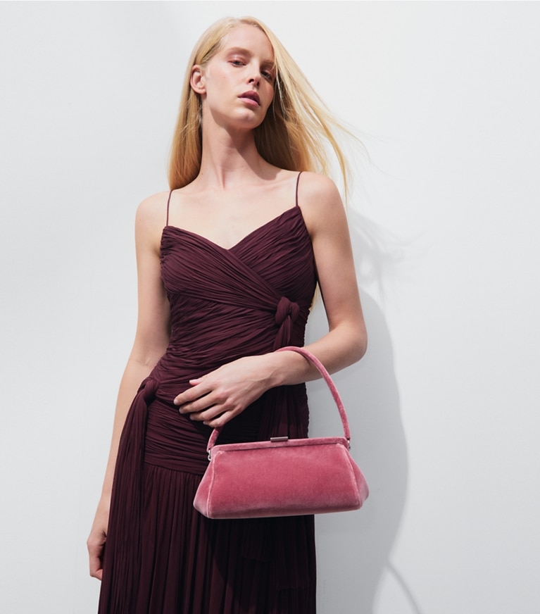 Tory Burch designer clutches Velvet Frame Clutch in Desert Flower accessory on model