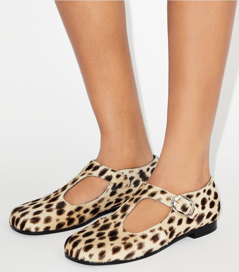 Tory Burch designer flats Violet T-Strap in CHEETAH SPOTS accessory on model
