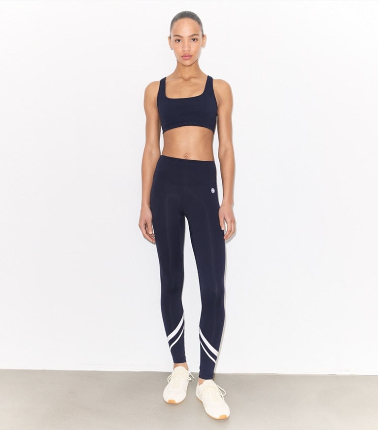 Tory Sport designer bottoms Weightless Chevron Legging in Tory Navy / Snow White on model front