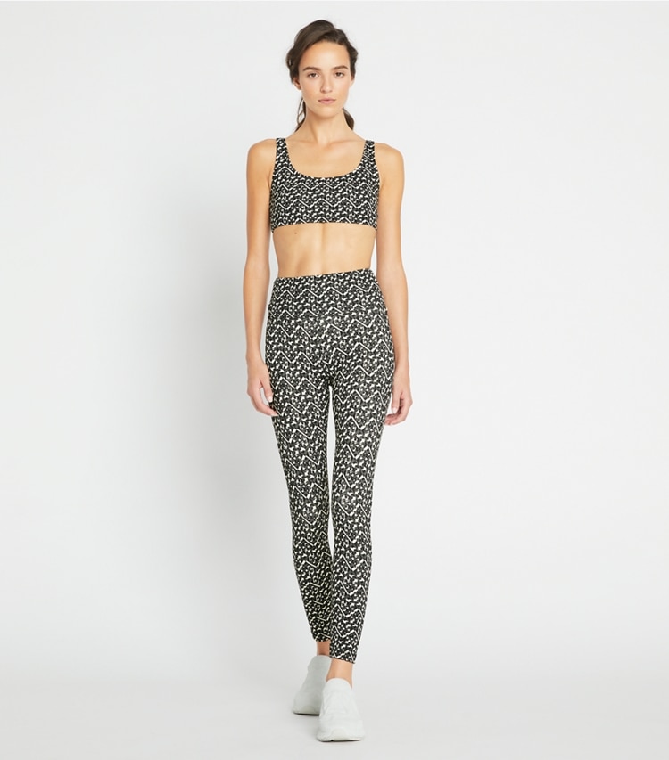 Tory Sport designer bottoms Weightless Printed 7/8 Legging in Mini Prismatic T Monogram on model front