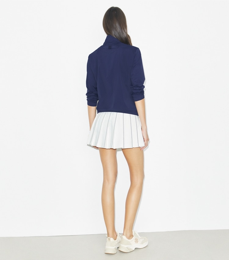 Tory Burch designer bottoms X-Embroidered Pleated Tennis Skirt in Snow White on model back