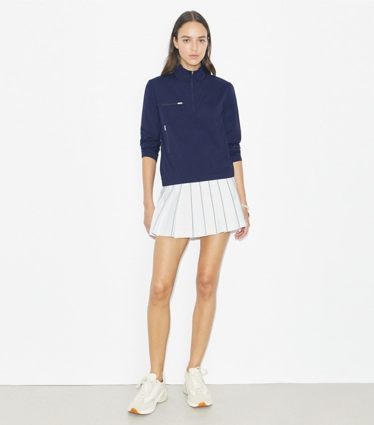 Tory Burch designer bottoms X-Embroidered Pleated Tennis Skirt in Snow White on model front