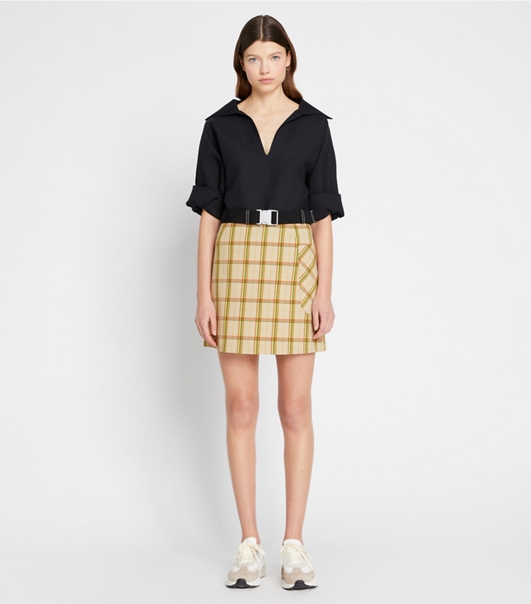 Tory Sport designer bottoms Yarn-Dyed Twill Club Skirt in Beige Party Plaid on model front